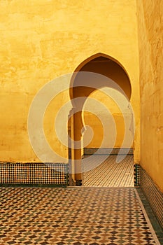 Bright yellow islamic arches and patios in Meknes, Morocco