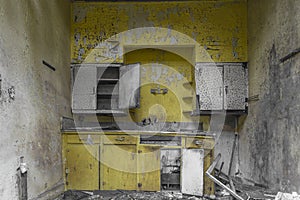 Bright yellow kitchen in an abandoned house