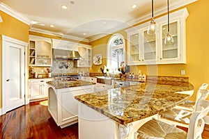 Bright yellow kitchen room with granite tops