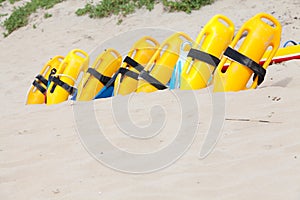 Bright yellow life saving equipment on the beach sand