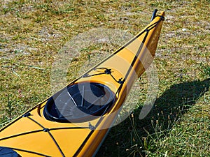 Bright yellow sea kayak on the beach