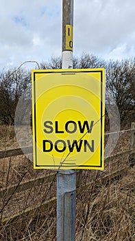 Bright yellow slow down sign