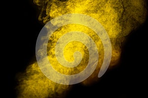 Bright yellow smoke isolated on black background is macro