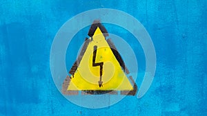 Bright yellow warning sign High voltage on blue