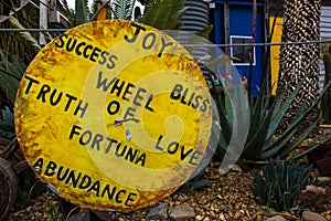 A Bright Yellow Wooden Wheel of Truth and Love