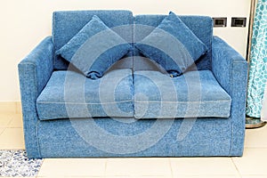 Brightly and classic suite, Hotel room with modern interior, blue couch, pillows. holiday relaxation vacation concept