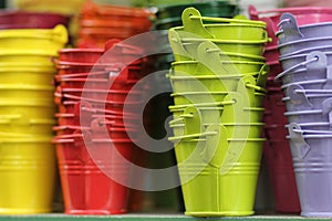 Brightly colored buckets at the flower market in Paris