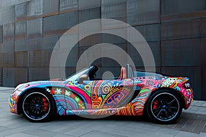 A brightly colored car stands parked in front of a contemporary building, adding a vibrant pop of color to the urban scene, A
