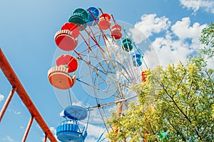 Brightly colored Ferris wheel against the blue sky