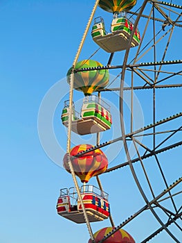 Brightly colored Ferris wheel against the blue sky