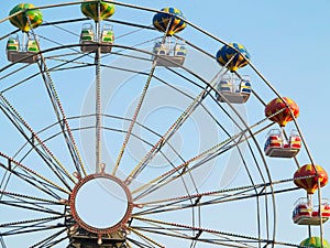 Brightly colored Ferris wheel against the blue sky