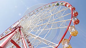 Brightly colored ferris wheel against the blue sky