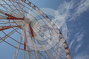 Brightly colored Ferris wheel. Ferris wheel on a bright sunny day
