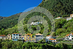 Brightly colored houses on mountainous island