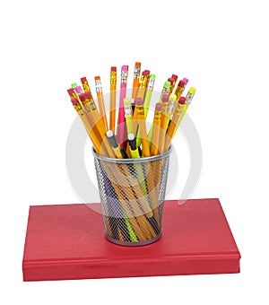 Brightly Colored Pencils Resting On a Red Book