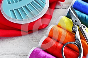 Brightly Colored Spools of Thread and Sewing Needles