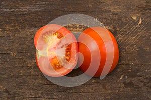 Brightly colored tomato cut in half with one side