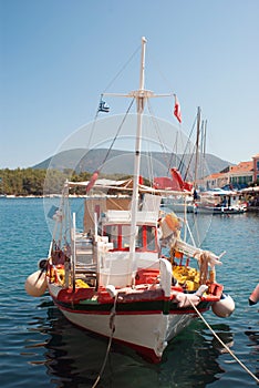 Brightly coloured blue and red fishing boat in harbour