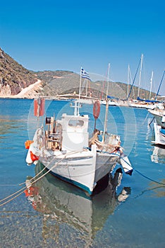 Brightly coloured blue and red fishing boat in harbour