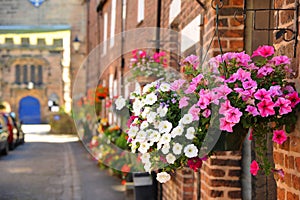 Brightly coloured floral baskets in the pretty English floral village of Croston