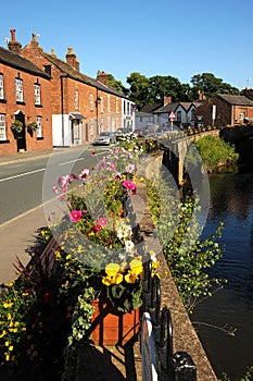 Brightly coloured floral baskets in the pretty English floral village of Croston