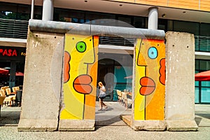 Brightly coloured graffiti on a segment of the original Berlin Wall.