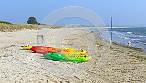 Brightly coloured pedalos Studland knoll beach Dorset England UK