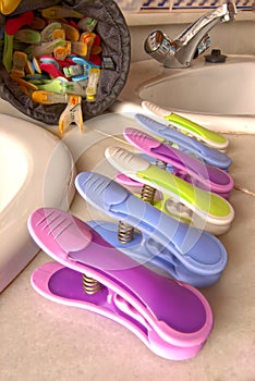 Brightly coloured washday clothes pegs.