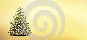 Brightly decdecorated Christmas tree isolated on golden background