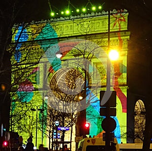 Brightly illuminated Arc de Triomphe on New Year`s Eve 2017/18. Paris, France