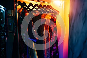 brightly lit boutique corner with rack of highend designer evening dresses