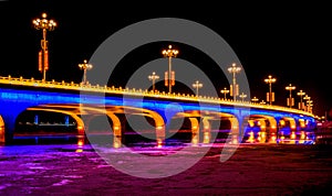 Brightly lit bridge at night