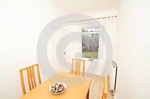 brightly lit dining room with view of the back garden