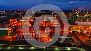 Brightly lit gas and oil refinery complex at night aerial