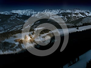 Brightly Lit Mountain Christmas Tree Glows in Snow