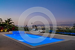 Brightly lit pool under a starry night sky in Encino, California