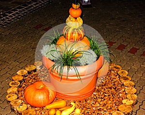 Brightly lit pumpkin pyramid in flowerpot