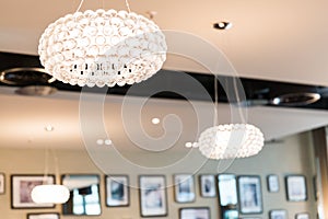 Brightly Lit Round Ceiling Lighting in Restaurant with Blurred Background