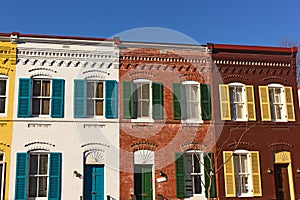 Brightly painted brick houses on the street of Washington DC neighborhood, USA.