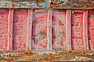 Brightly painted hull of old wooden boat.