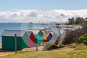 Brighton Beach colorful cabins with the Melbourne skyline, Melbourne, Victoria, Australia