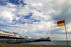 Brighton: beach surf rescue flag and pier