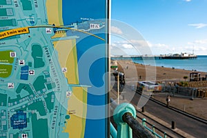 Brighton, England-1 October,2018: Asian young traveler read and point to the Brighton City town and Brighton Pier map on the board