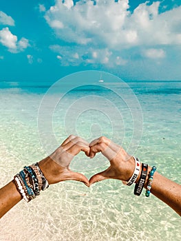 Hand heart on paradise bikini beach Maldives photo