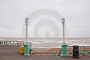 Brighton promenade with lamppost in rainy day.