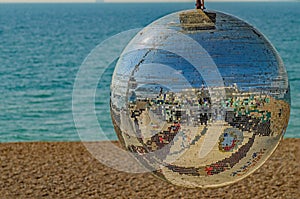 A Brighton seafront glitterball reflecting like a smiling face