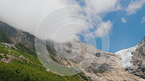 Briksdal glacier in the summer. Ice remained only on the top of the mountain. The glacier is known for changing its size