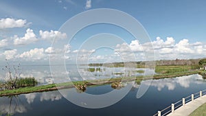 Brilliant blue sky and clouds relect on Lake Apopka at Winter Garden Florida