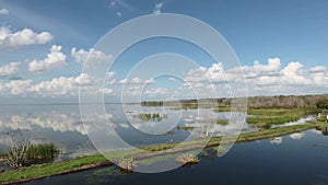 Brilliant blue sky and clouds relect on Lake Apopka at Winter Garden Florida