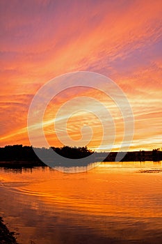 Brilliant Colours In The Sky As The Sun Sets Over The Lake